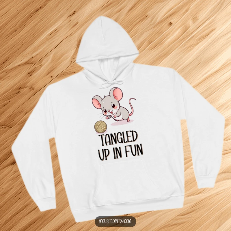 Funny hoodie with a cute kawaii mouse deeply engrossed in playfully chasing a ball of string, radiating cozy and playful vibes.